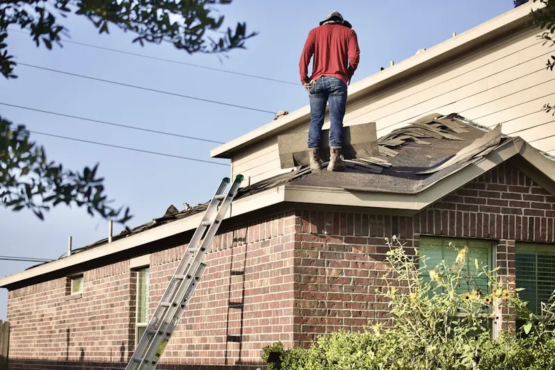 Professional roofer working on a residential roof in Fort Belvoir